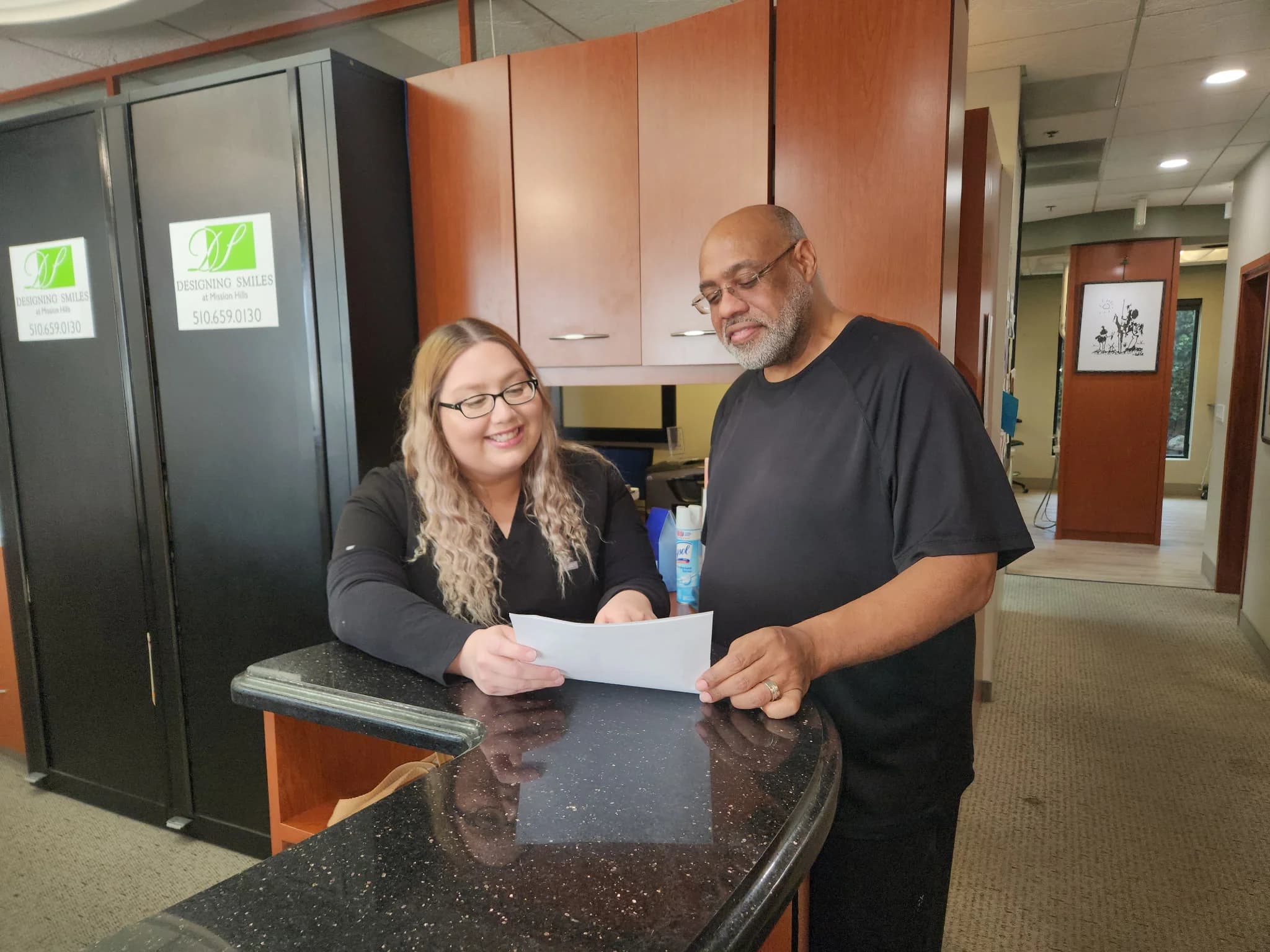 Patient reviewing dental financing options with the manager
